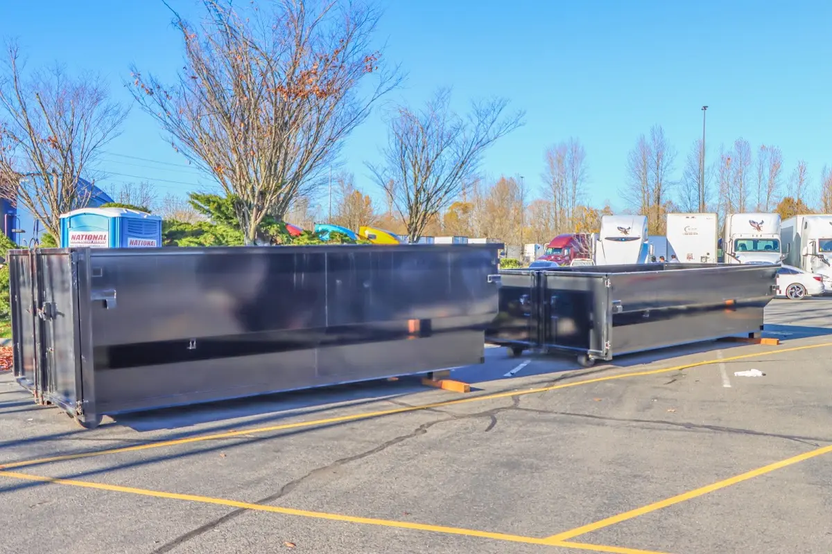 Professional dumpster rental service with roll-off container on residential driveway in Hendersonville